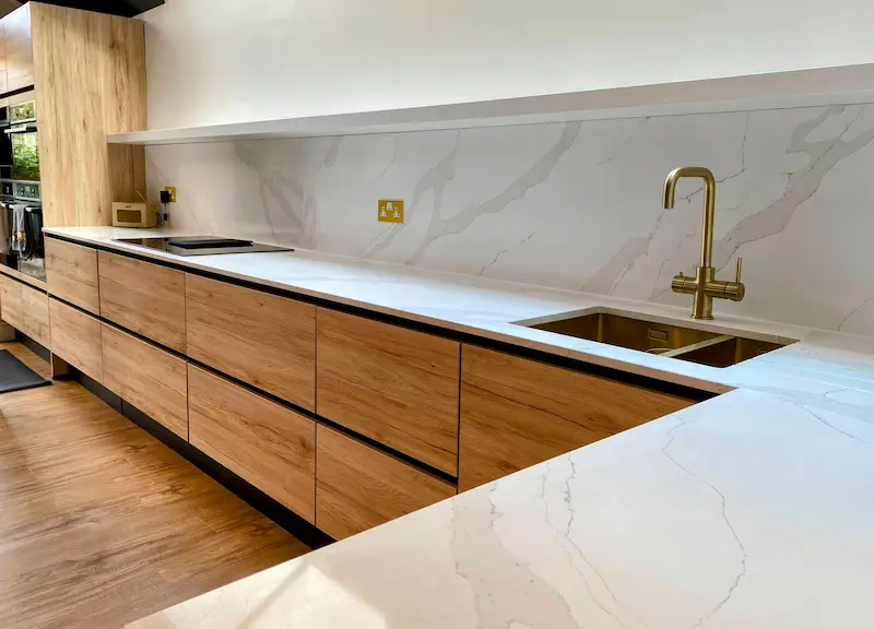Beautiful kitchen featuring warm oak cabinetry and modern appliances. Stunning design showcasing natural wood finishes, contemporary lighting, and premium appliances creating the perfect culinary workspace for modern living.